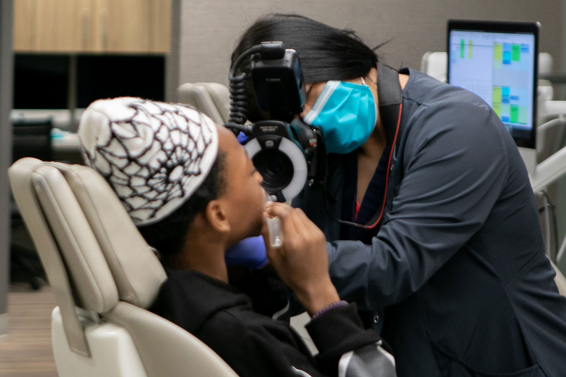 assistant taking photos of patient's teeth